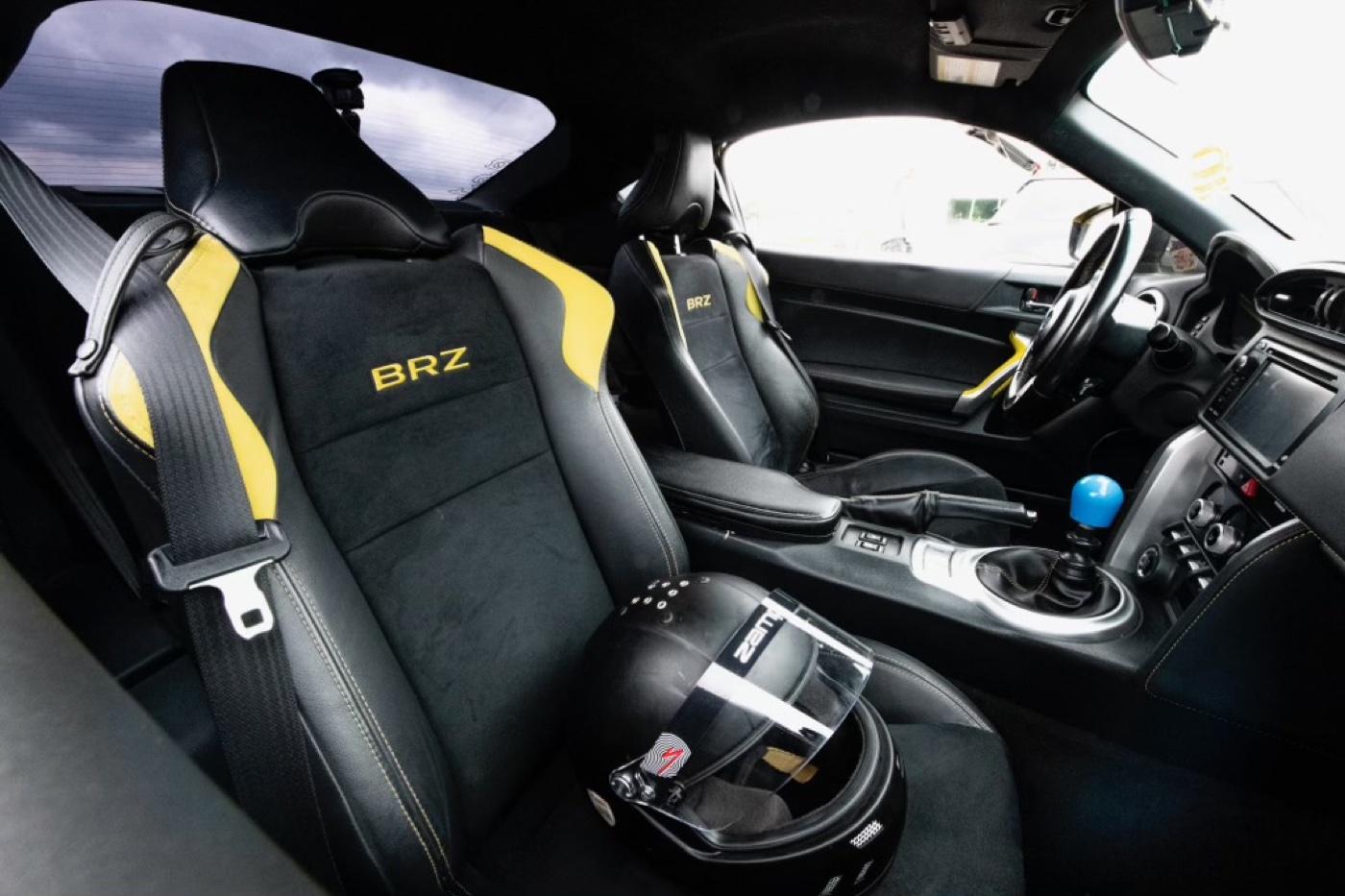 BRZ racing interior with bolstered seats and helmet